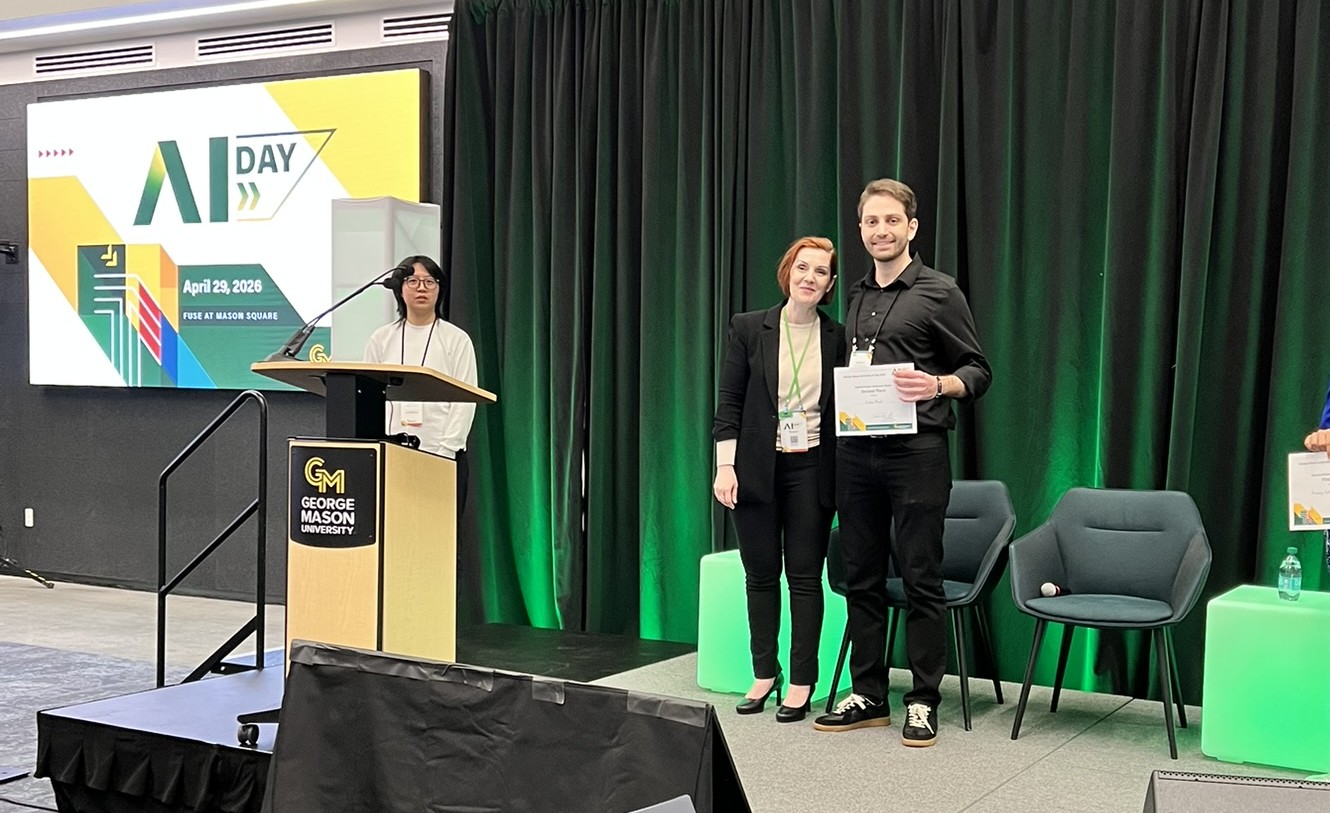 Erdem Murat with his Mason AI Day poster on VR and AI firefighter training